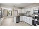 Open kitchen with new stainless steel dishwasher, cabinets and granite counters at 1310 43Rd S St, St Petersburg, FL 33711
