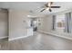 Bright and spacious living room with modern flooring, ceiling fan, and an open layout to the kitchen at 1310 43Rd S St, St Petersburg, FL 33711