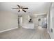 Bright and spacious living room with modern flooring, ceiling fan, and an open layout to the kitchen at 1310 43Rd S St, St Petersburg, FL 33711