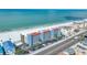 Beautiful aerial view of the condo community nestled along a pristine white sand beach with clear turquoise ocean waters at 13720 Gulf Blvd # 302, Madeira Beach, FL 33708