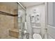 Bathroom boasts a beige tiled shower with a seating bench and glass doors, plus white towels hung on the wall at 13720 Gulf Blvd # 302, Madeira Beach, FL 33708