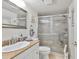 The bathroom features granite counters, a framed mirror, and a glass-enclosed shower at 13720 Gulf Blvd # 302, Madeira Beach, FL 33708