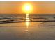Seaside view of a tranquil beach at sunset with birds foraging along the shore at 13720 Gulf Blvd # 302, Madeira Beach, FL 33708
