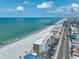 A breathtaking aerial showcases beachfront condos along the pristine beach and turquoise waters at 13720 Gulf Blvd # 302, Madeira Beach, FL 33708