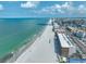 Beautiful aerial showcases condos along the pristine beach and turquoise waters with roads nearby at 13720 Gulf Blvd # 302, Madeira Beach, FL 33708