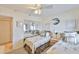 Bright bedroom features twin beds with palm-printed bedding, a mirrored closet, and coastal decor at 13720 Gulf Blvd # 302, Madeira Beach, FL 33708