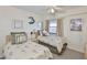 Bright bedroom with two twin beds, coastal decor, and a window with peaceful views at 13720 Gulf Blvd # 302, Madeira Beach, FL 33708