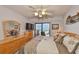 Bedroom with a ceiling fan, and sliding doors to the lanai with gulf views at 13720 Gulf Blvd # 302, Madeira Beach, FL 33708