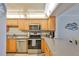 Modern kitchen featuring stainless steel appliances, ample cabinetry, and a cozy breakfast bar at 13720 Gulf Blvd # 302, Madeira Beach, FL 33708