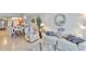 Bright and airy living area with open layout, tile floors, stylish furniture, and views of the dining area and kitchen at 13720 Gulf Blvd # 302, Madeira Beach, FL 33708