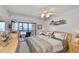 Bedroom with a ceiling fan, sliding doors to the lanai, and gulf views at 13720 Gulf Blvd # 302, Madeira Beach, FL 33708