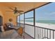 Enjoy the beach views from this relaxing porch, featuring a ceiling fan and comfortable chaise lounge at 13720 Gulf Blvd # 302, Madeira Beach, FL 33708