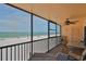 Enjoy unobstructed beach views from this screened patio with comfortable seating and a ceiling fan at 13720 Gulf Blvd # 302, Madeira Beach, FL 33708