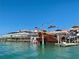A waterfront scene with a tall ship and a lighthouse among colorful buildings on a clear, sunny day at 13720 Gulf Blvd # 302, Madeira Beach, FL 33708