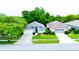 Aerial view of a single-story home with a two-car garage, mature landscaping, and great curb appeal at 14116 Whitecap Ave, Hudson, FL 34667
