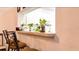 Counter with bar-stool seating, a pass-through window, and bright plants at 14116 Whitecap Ave, Hudson, FL 34667