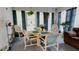 Breakfast nook features a quaint dining table surrounded by large windows with backyard views at 14116 Whitecap Ave, Hudson, FL 34667