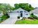 Charming single-story home features a well-manicured lawn, attached two-car garage, and freshly painted exterior at 14116 Whitecap Ave, Hudson, FL 34667