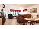 Open concept living and dining area featuring vaulted ceilings and vinyl floors at 14116 Whitecap Ave, Hudson, FL 34667