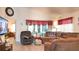 Cozy living room with vaulted ceilings, sliding glass doors to patio, and comfortable seating at 14116 Whitecap Ave, Hudson, FL 34667