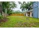 Expansive backyard features mature trees, a wooden fence, and a blank slate to create your outdoor oasis at 14902 Foxhound Pl, Tampa, FL 33624