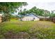 Large backyard, bordered by a wooden fence, with plenty of room for recreation and entertaining at 14902 Foxhound Pl, Tampa, FL 33624