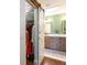 Modern bathroom with a barn door, dual vanity, and a view into a walk-in closet at 14902 Foxhound Pl, Tampa, FL 33624