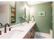 Modern bathroom featuring a double vanity, sleek fixtures, and decorative accents at 14902 Foxhound Pl, Tampa, FL 33624