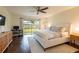 Primary bedroom featuring a ceiling fan and sliding glass doors to the backyard at 14902 Foxhound Pl, Tampa, FL 33624