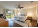 Primary bedroom featuring a ceiling fan and sliding glass doors to the backyard at 14902 Foxhound Pl, Tampa, FL 33624