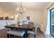 An inviting dining room featuring wood floors, modern lighting, and an open layout at 14902 Foxhound Pl, Tampa, FL 33624