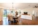 Dining area with a dark wood table, upholstered chairs, sliding glass doors, and views of the backyard at 14902 Foxhound Pl, Tampa, FL 33624