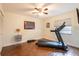 A simple exercise room with a treadmill and free weights, perfect for a home gym setup at 14902 Foxhound Pl, Tampa, FL 33624