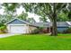 Charming single Gathering home with a well manicured lawn and attached garage at 14902 Foxhound Pl, Tampa, FL 33624