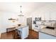 Bright kitchen featuring white cabinets, stainless steel appliances, granite countertops, and modern lighting fixtures at 14902 Foxhound Pl, Tampa, FL 33624