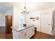 Charming kitchen with a granite island, wooden stools, stainless steel appliances, and ample storage space at 14902 Foxhound Pl, Tampa, FL 33624