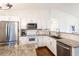 Bright white kitchen featuring granite countertops, stainless steel appliances and subway tile backsplash at 14902 Foxhound Pl, Tampa, FL 33624