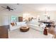 Open-concept living area with stylish furnishings, hardwood floors, and abundant natural light throughout at 14902 Foxhound Pl, Tampa, FL 33624