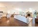 Inviting living space with hardwood floors, fireplace, and open to a modern kitchen and dining area at 14902 Foxhound Pl, Tampa, FL 33624