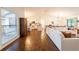 Spacious living area flowing into a dining area and open kitchen, showcasing natural light and hardwood floors at 14902 Foxhound Pl, Tampa, FL 33624