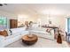 Bright and airy living room featuring a large white sectional, modern round table, and open floor plan at 14902 Foxhound Pl, Tampa, FL 33624