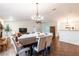Open concept living and dining area with natural light, wood floors, and stylish decor throughout at 14902 Foxhound Pl, Tampa, FL 33624