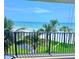 Enjoy breathtaking beach views from this balcony with palm trees, and the ocean, perfect for relaxation at 16330 Gulf Blvd # 201, Redington Beach, FL 33708