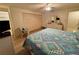 A well-lit bedroom includes a ceiling fan, spacious closet, and comfortable furnishings at 16330 Gulf Blvd # 201, Redington Beach, FL 33708