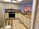 Well-lit kitchen featuring neutral countertops, and white appliances and cabinets at 16330 Gulf Blvd # 201, Redington Beach, FL 33708