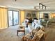 Open living space with a cozy seating area and access to a balcony for outdoor enjoyment at 16330 Gulf Blvd # 201, Redington Beach, FL 33708