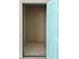Empty and secure bright storage closet featuring a smooth interior and an easy-to-open bright blue door at 16330 Gulf Blvd # 201, Redington Beach, FL 33708
