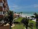 Stunning ocean view from the property, showcasing a tropical setting with lush trees at 16330 Gulf Blvd # 201, Redington Beach, FL 33708