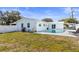 Private backyard with a pristine pool, set against a backdrop of green grass and clear blue skies at 1701 66Th N Ave, St Petersburg, FL 33702