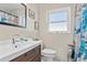 Bathroom features a shower with a modern map curtain, a vanity, and a mirror at 1701 66Th N Ave, St Petersburg, FL 33702
